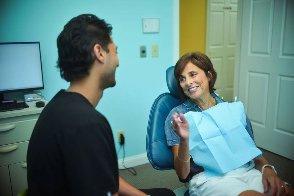 Dr. Parth Maheshwari talking with a smiling patient at Seven Hills General Dentistry